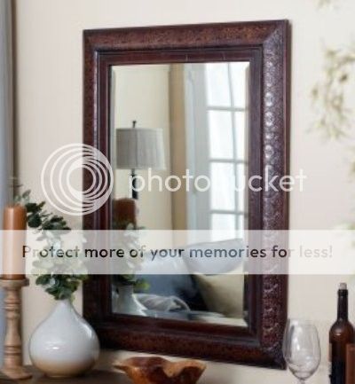   mirror features an embossed design on a copper over wood the copper